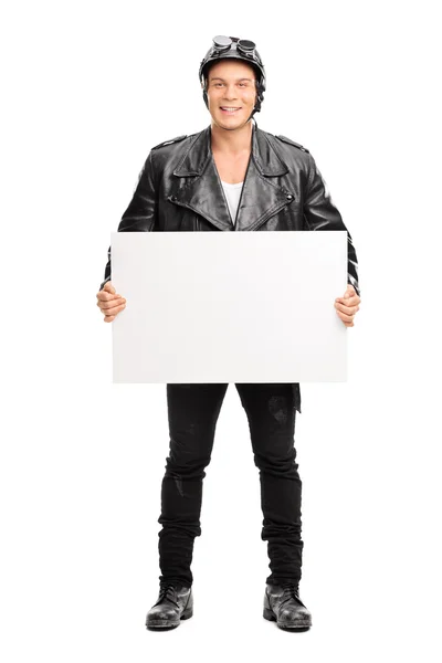 Young male motorcyclist holding a signboard — Stock Photo, Image