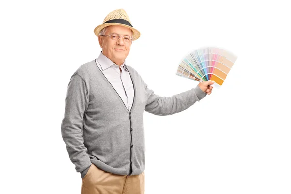 Senior gentleman holding a color swatch — Stock Photo, Image
