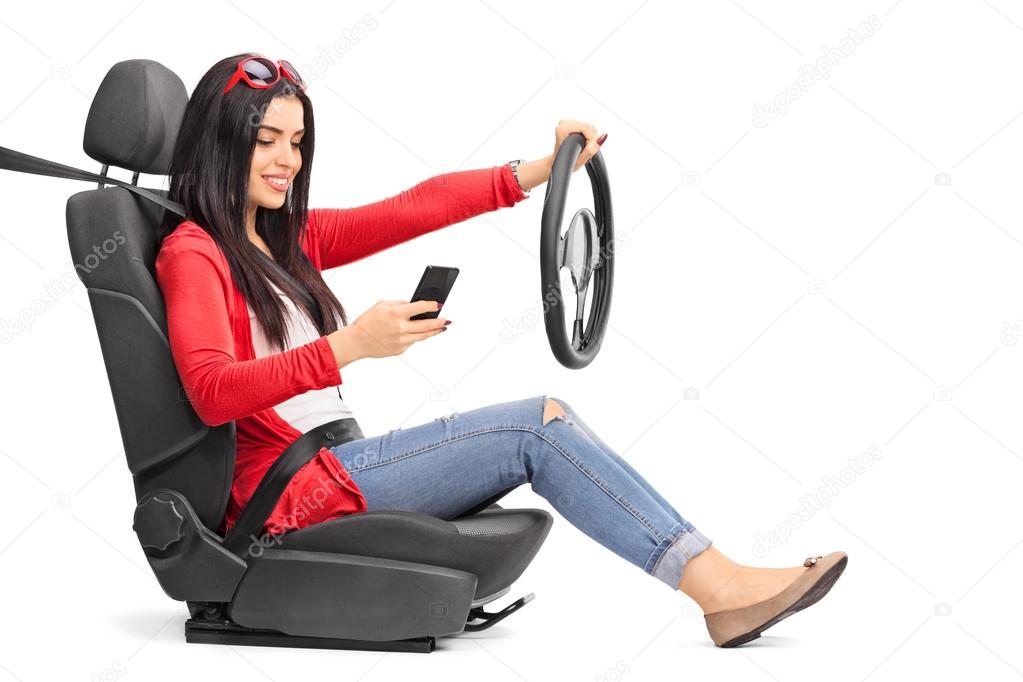 Young woman texting and driving 