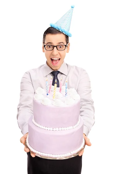 Young man handing a birthday cake — Zdjęcie stockowe