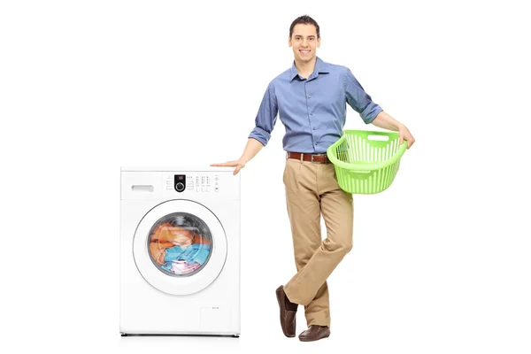 Guy holding an empty laundry basket — 스톡 사진