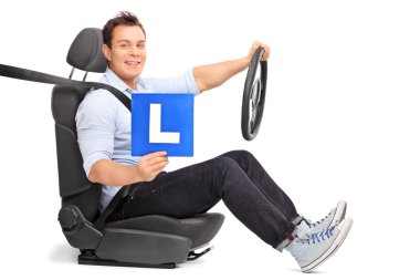 Man with L-sign seated on a car seat