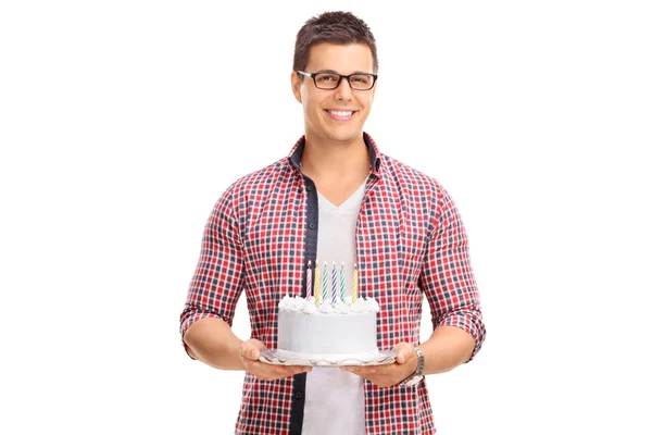 Cheerful guy holding a birthday cake — ストック写真