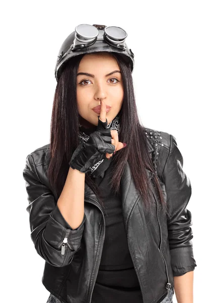 Female biker holding a finger on lips — Stok fotoğraf