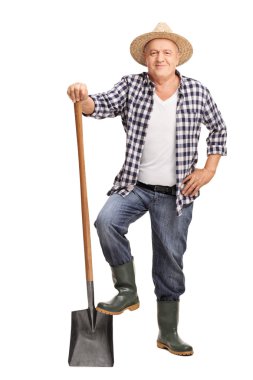 Mature farmer posing with a shovel 
