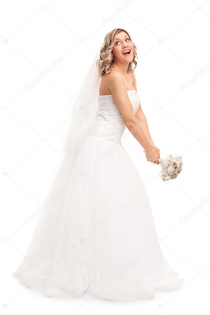Young bride tossing her wedding bouquet 