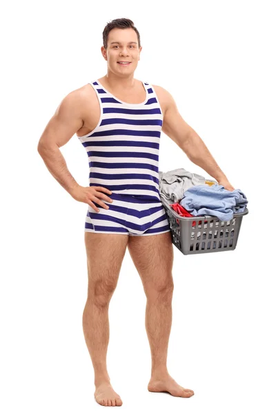 Man in underwear holding a laundry basket — Stock Photo, Image