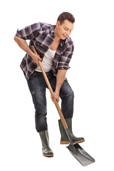 Young farmer digging with a shovel — Stock Photo, Image