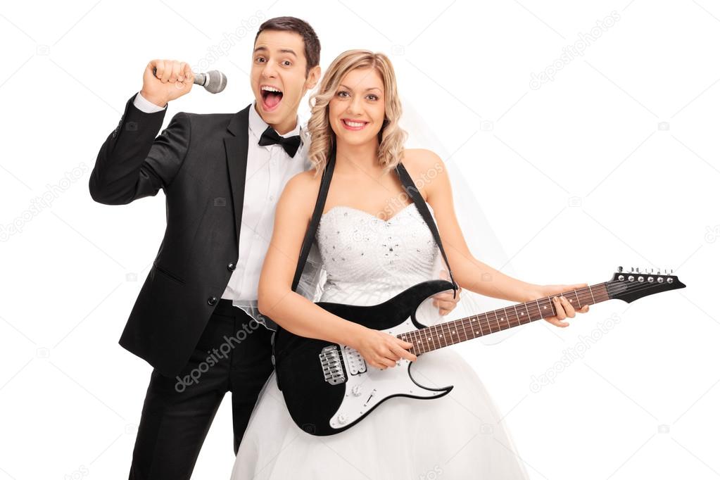 Bride playing guitar and the groom signing