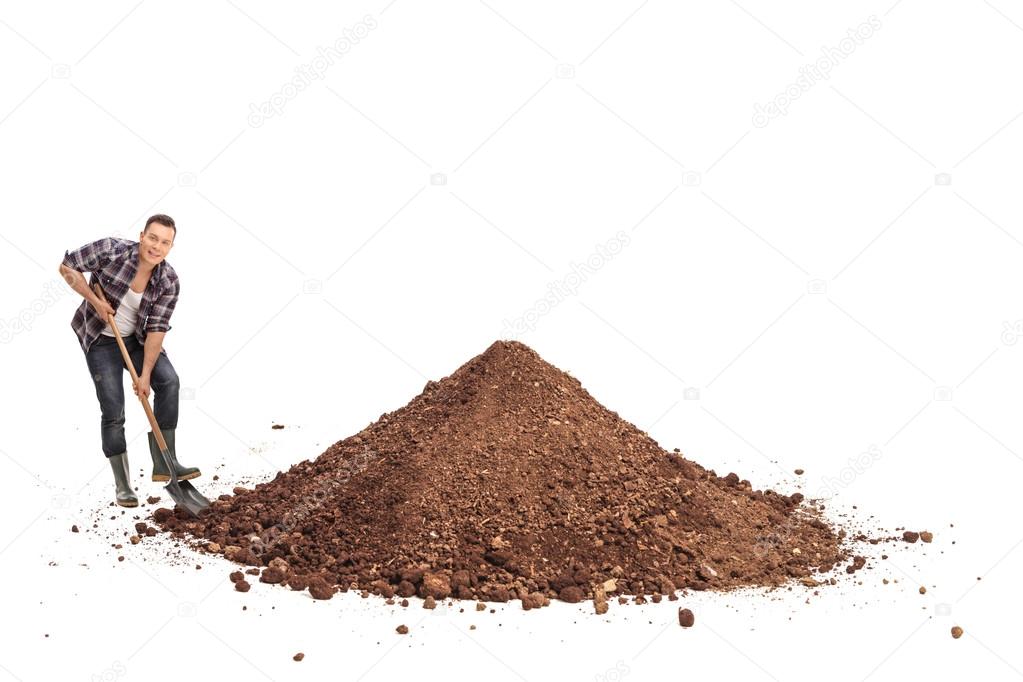 Manual worker shoveling a pile of dirt 