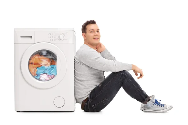 Young man waiting for the laundry — Stock Photo, Image