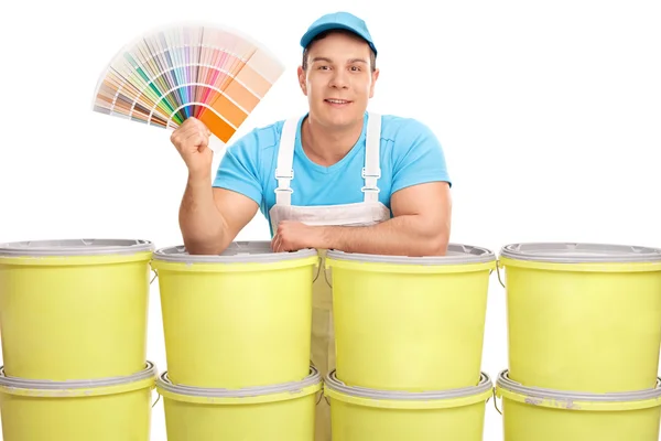 Cheerful decorator holding a color swatch — Stock Photo, Image