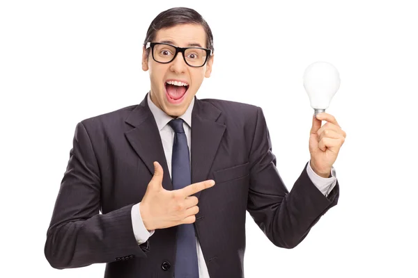 Excited businessman holding a light bulb — Stock Photo, Image