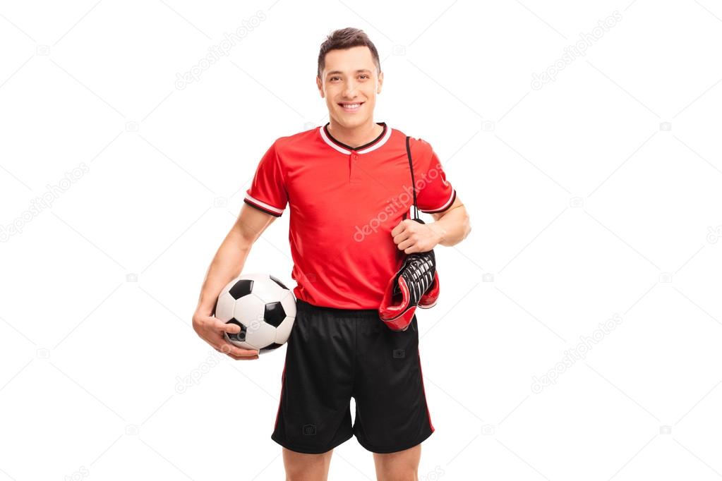 Football player carrying a pair of boots 