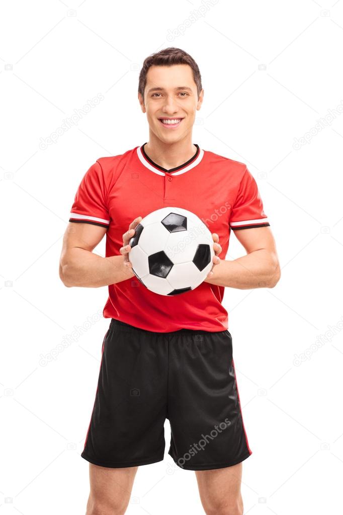 Young football player holding a ball 