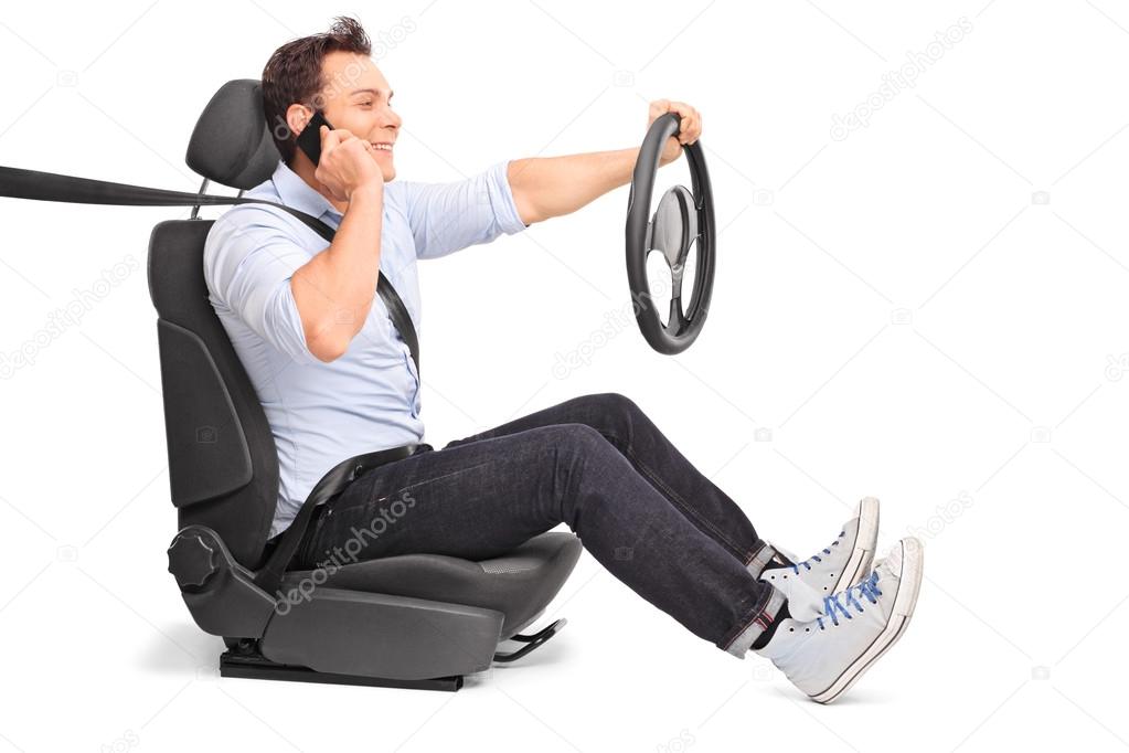 Young man driving and talking on phone 