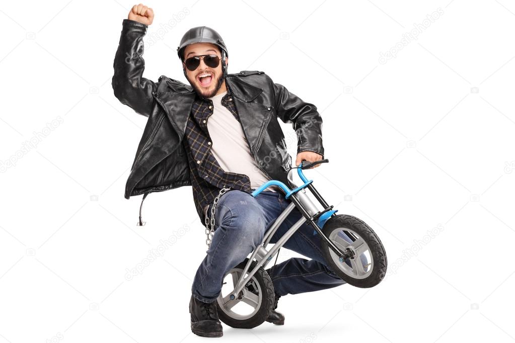 Joyful biker riding a small bicycle