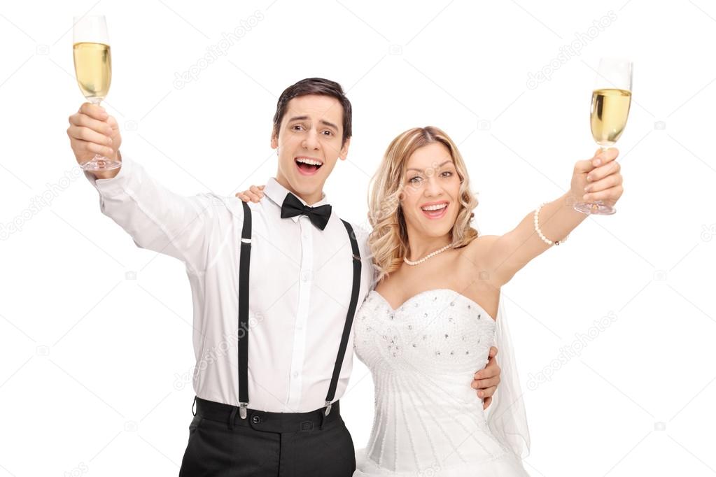 Newlywed couple making a toast with wine 