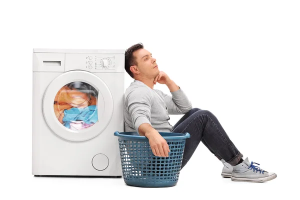 Bored man waiting for the laundry — Stock Photo, Image