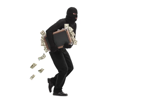 Einbrecher läuft mit einer Tasche voller Geld davon — Stockfoto