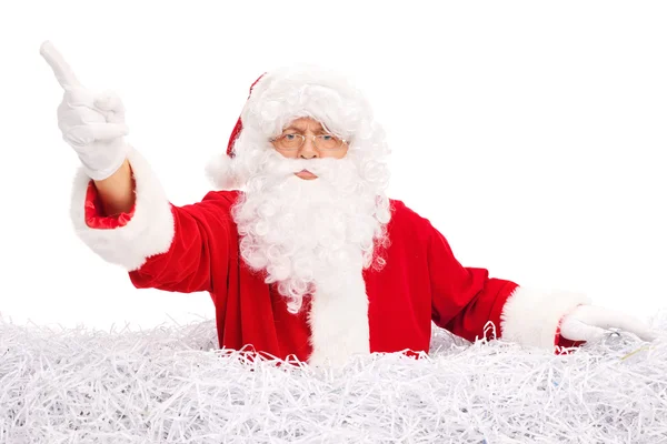 Santa standing in a pile of shredded paper — Stockfoto