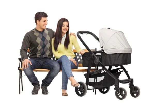 Young parents with a baby stroller — Stock Photo, Image