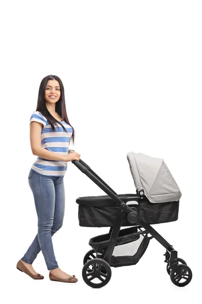 Cheerful mother pushing a baby stroller — Stock Photo, Image