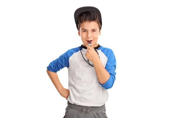 Cheerful boy in sportswear blowing a whistle — Stock Photo, Image