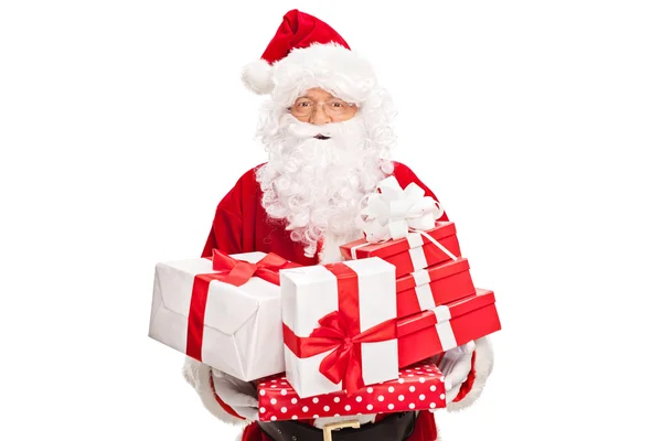 Santa Claus holding a bunch of presents — Stock Photo, Image