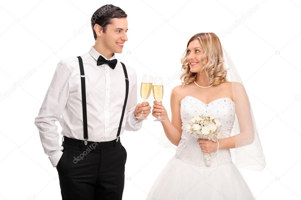 Newlywed couple making a toast with wine 