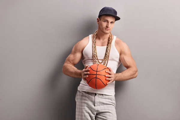 Young man holding a basketball — Stock Photo, Image