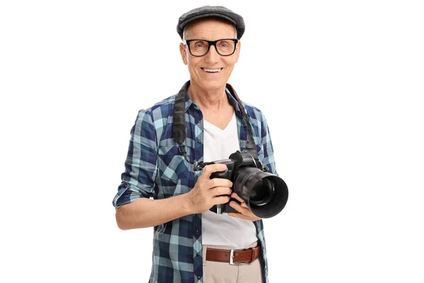 Senior photographer holding a black camera — Stock Photo, Image