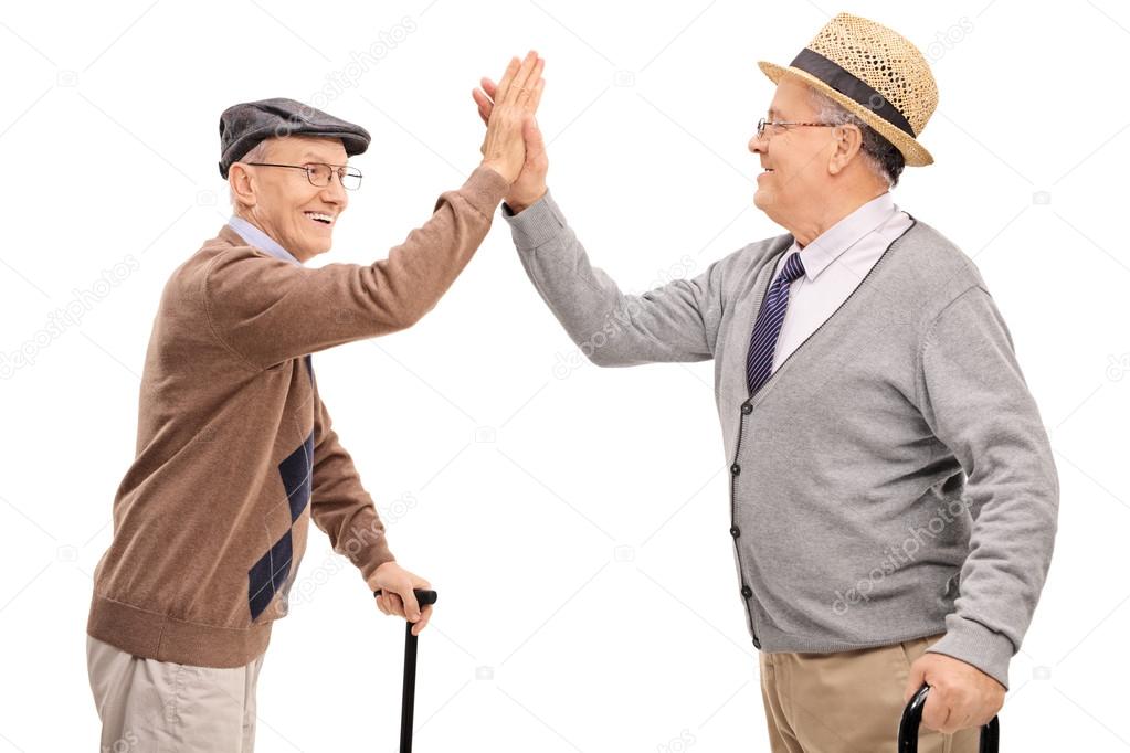 senior gentlemen high-five each other