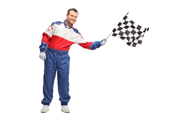 Young man waving a checkered race flag — Stock Photo, Image