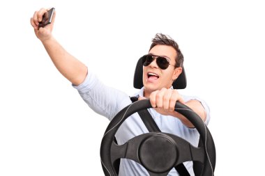 Young man driving and taking a selfie  clipart