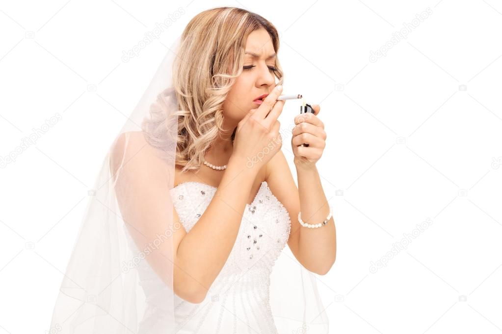 Young nervous bride lighting up a cigarette 