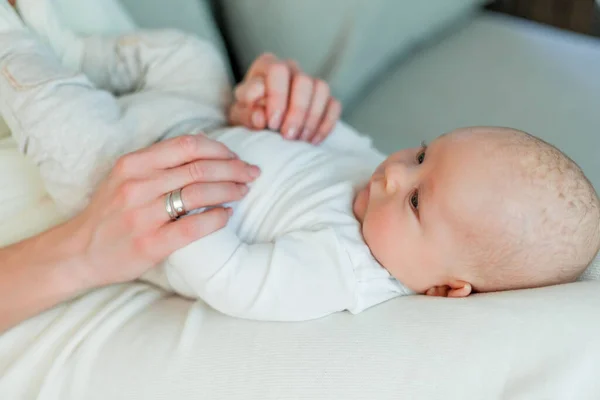 Baby. Beautiful young happy mom and baby. Mom holds the baby in her arms. Love.