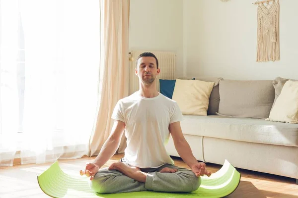 Young man doing yoga. Online classes at home.