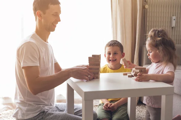 Happy family playing board game together.