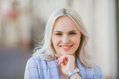 Portrait of a beautiful young woman in a European city. Makes purchases. Tourism.