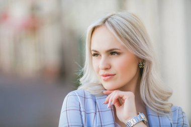 Portrait of a beautiful young woman in a European city. Makes purchases. Tourism.