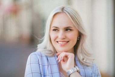Portrait of a beautiful young woman in a European city. Makes purchases. Tourism.