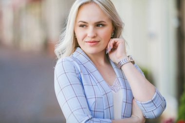 Portrait of a beautiful young woman in a European city. Makes purchases. Tourism.