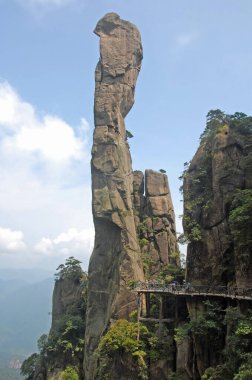 Sanqingshan Mountain in Jiangxi Province, China. View of Snake Rock or Python Rock, a pinnacle on Mount Sanqing, with path and tourists. Sanqingshan is a Taoist mountain famous for its rocky peaks. clipart