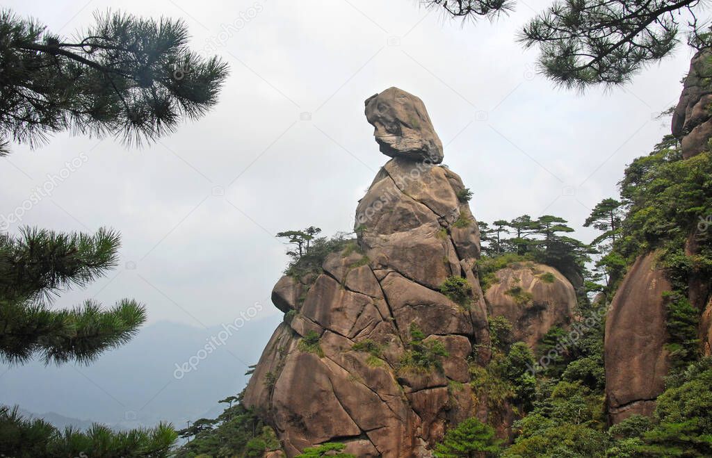Sanqingshan Mountain in Jiangxi Province, China. View of Goddess Peak, a rocky outcrop on Mount Sanqing representing a woman looking to the distance. Sanqingshan is a Taoist mountain with lush forests
