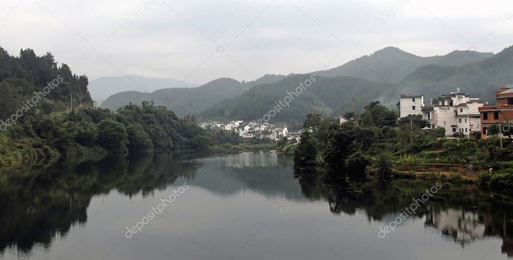 Wangkou in Wuyuan County, Jiangxi Province, China. Wangkou is an ancient town in Wuyuan County which is known for its Tang Dynasty architecture. Traditional white houses with river and hills.