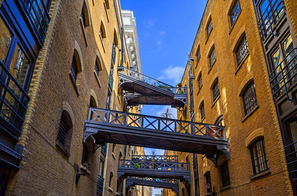 Shad Thames in London, UK. Historic Shad Thames is an old cobbled street known for its restored overhead bridges and walkways. This old street is in Bermondsey near Tower Bridge and London Bridge.