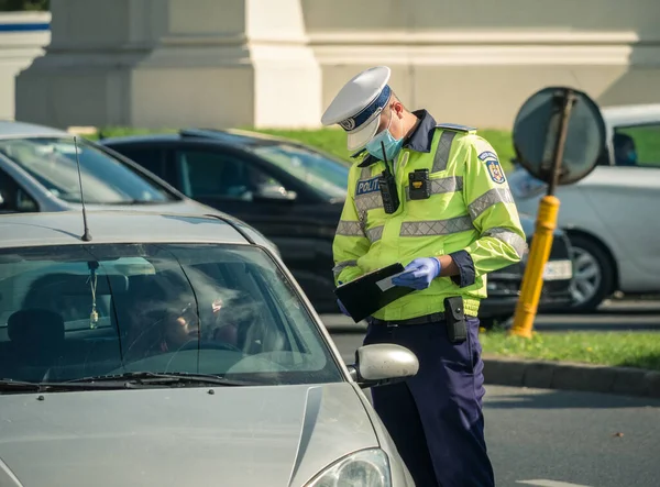 Stock image Bucharest/Romania - 10.17.2020: Traffic police officer writing a ticket to a female driver who broke the law.