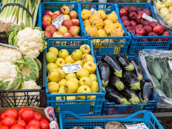 Fresh fruits and vegetables on display in a market in Bucharest. with prices in romanian currency