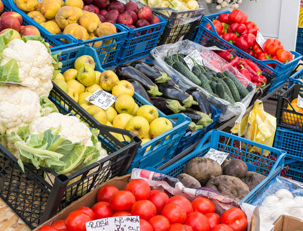 Fresh fruits and vegetables on display in a market in Bucharest. with prices in romanian currency